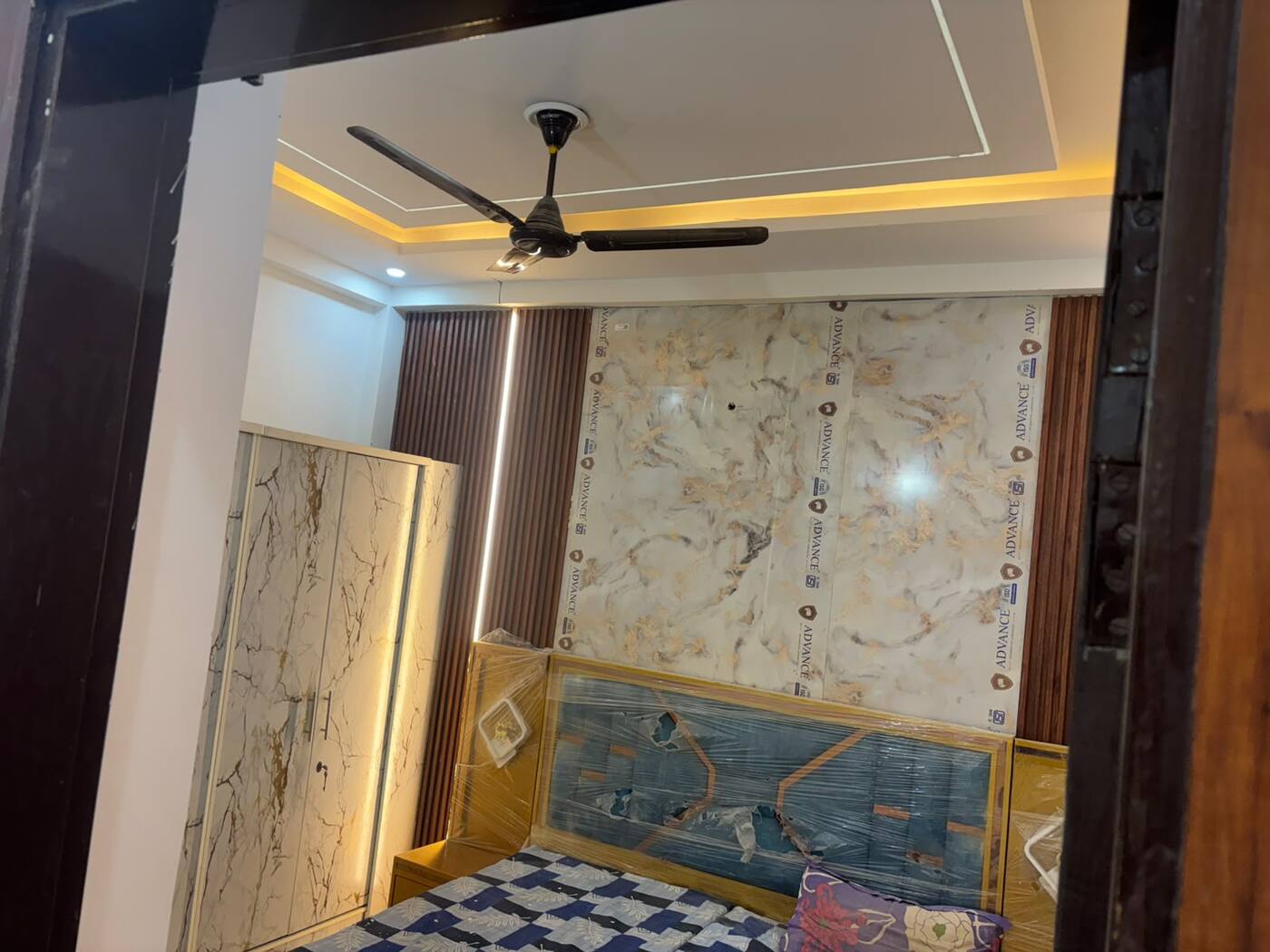 Furnished bedroom with wardrobe and cove lighting