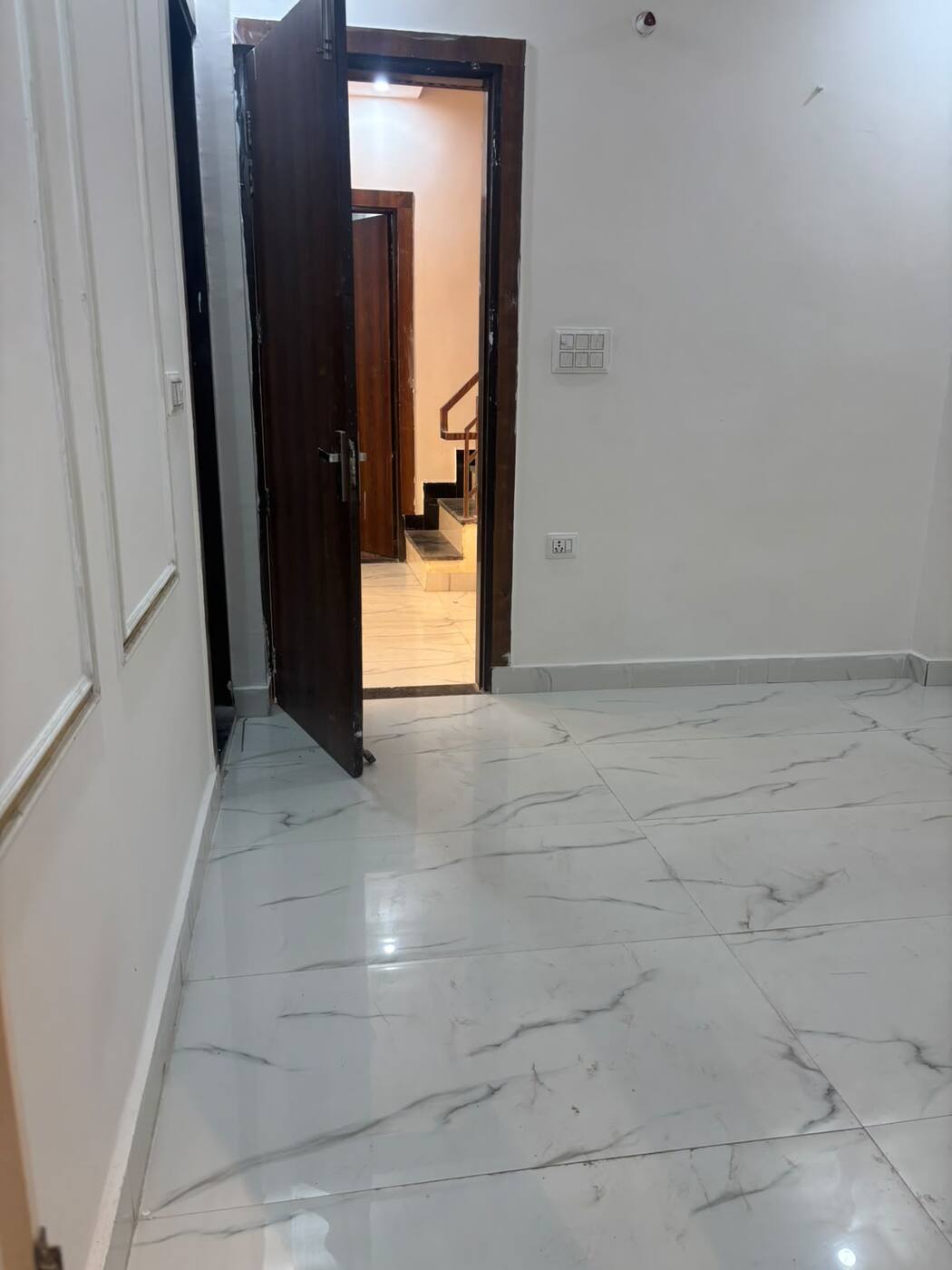 Room with large marble-finish floor tiles