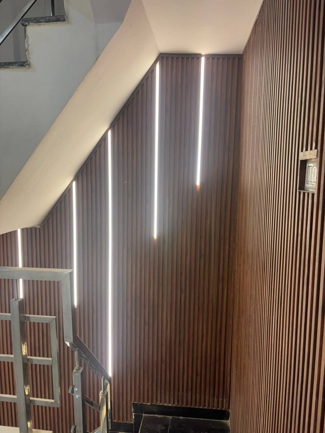 Wooden slat wall with vertical strip lights
